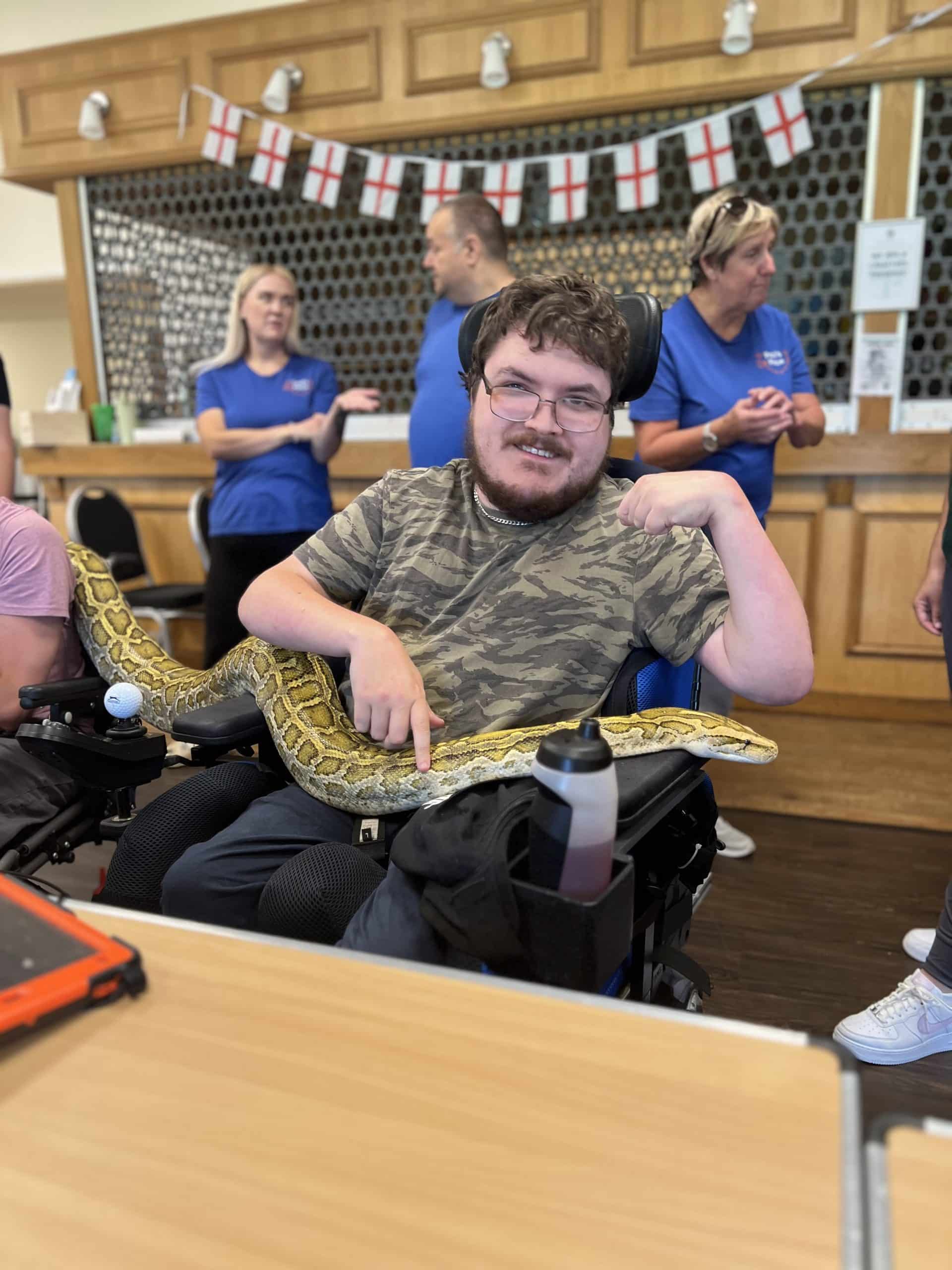 Isaac holding a python during Animal Interactive August 2024