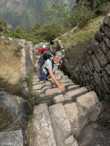 female hiker, climbing steps in Machu Picchu