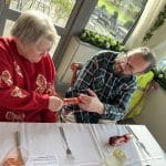 Avril and Dave Owen pulling a Christmas cracker at the Christmas Meal in the Kendleshire, 2024.